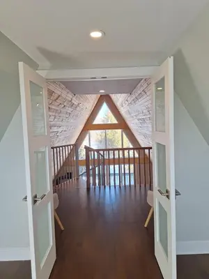 a room with two doors and a ceiling with a window at Elderado A-Frame