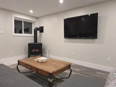 a living room with a fireplace and a flat screen tv at Elderado A-Frame