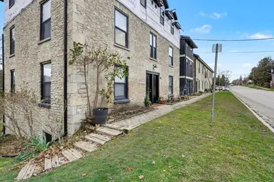 a brick building on a street with a yard at The Wynford Romantic Amalfi Escape in Elora