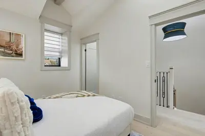 a white bedroom with a bed and a window at The Wynford Romantic Amalfi Escape in Elora