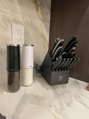a black knife block next to a container of knives at Navigate Stays Canada Luxury Hot Tub Retreat Home in Richmond Hill