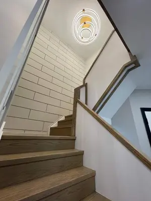 a staircase with a light on the ceiling at Navigate Stays Canada Luxury Hot Tub Retreat Home in Richmond Hill