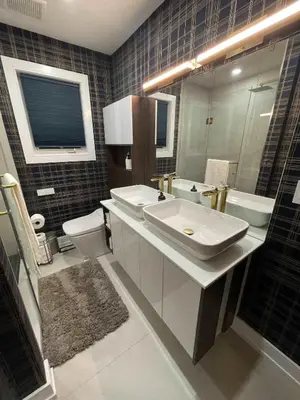 a bathroom with a sink and a toilet and a mirror at Navigate Stays Canada Luxury Hot Tub Retreat Home in Richmond Hill