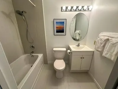 a bathroom with a tub and a toilet and a sink at Family Townhome with outdoor pool access in Collingwood