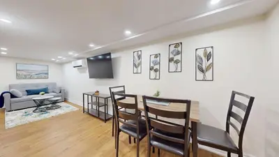 a living room with a table and chairs and a couch at Cozy Basement Apartment for 4 - Near Cafes & Parks in Toronto