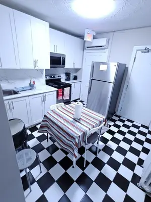 a kitchen with a black and white checkered floor at DOWNTOWN STAY-Free Wifi&Self Checkin in Toronto