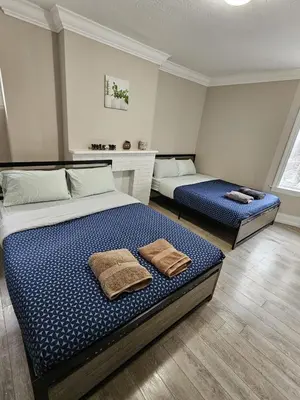 a bedroom with two beds with towels on them at DOWNTOWN STAY-Free Wifi&Self Checkin in Toronto