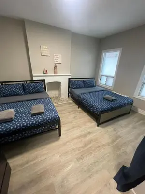 a large room with two beds and a table at DOWNTOWN STAY-Free Wifi&Self Checkin in Toronto