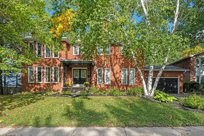 a brick house with a tree in front of it at 16 Guests Huge Spacious Home Near Ski Resorts in Barrie