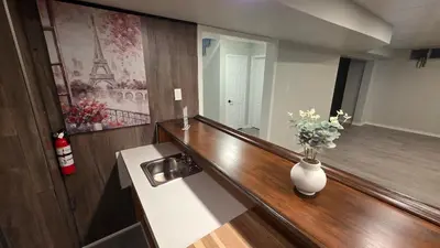 a bathroom with a sink and a vase with flowers in it at 16 Guests Huge Spacious Home Near Ski Resorts in Barrie