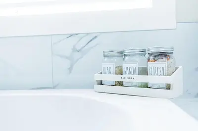 a shelf with three jars of herbs and spices at Sauna, Hot Tub & Heated Pool Blue Mountain Getaway in Blue Mountains