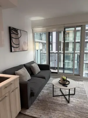 a living room with a couch and a table at Luxury Condo Downtown Toronto in Toronto