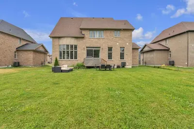 a large house with a large yard in front of it at Spacious & New Prince Edward County Villa in Carrying Place