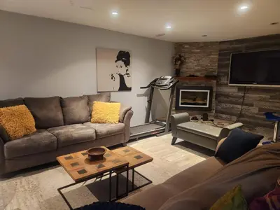 a living room with a couch and a fireplace at Cozy 2- bedroom private basement! in Mississauga