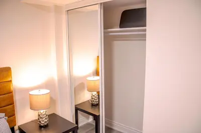 a mirror in a room with two tables and lamps at Oshawa Two Bedroom Private Suite in Oshawa