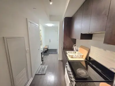 a small kitchen with a counter and a stove at Amazing one bedroom suite with panoramic downtown views in Toronto