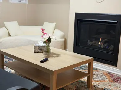 a living room with a coffee table and a fireplace at Cozy Private Basement Apartment in Fort Erie in Fort Erie
