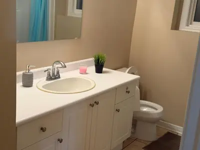a bathroom with a sink and a toilet at Cozy Private Basement Apartment in Fort Erie in Fort Erie