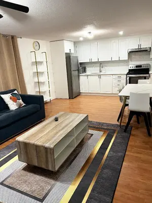 a living room with a couch and a table at Stunning Partially Renovated Apartment in Toronto