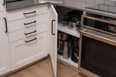 a kitchen with white drawers and a microwave at Beam Loft in Beamsville