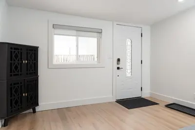 a white room with a door and a window at Beam Loft in Beamsville