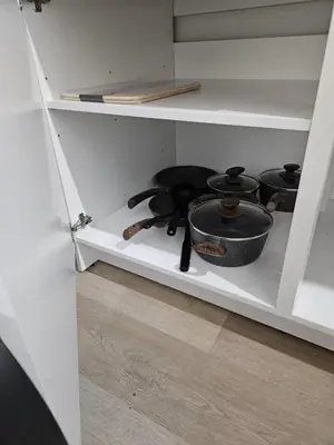 a white cabinet with a stove in a kitchen at Brand New Private Unit with Parking, Steps to TTC, 15 Minutes to Downtown in Toronto
