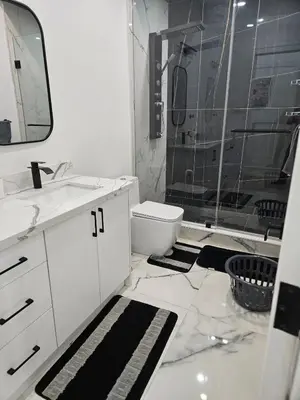 a bathroom with a sink and a toilet and a shower at Brand New Private Unit with Parking, Steps to TTC, 15 Minutes to Downtown in Toronto