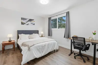 a bedroom with a bed and a desk and a desk at Waterloo Paradise with Rec room, Workspace, Park and close to St Jacobs Market in Waterloo
