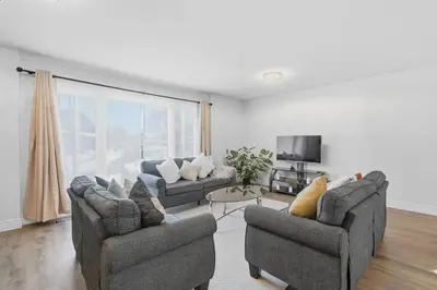 a living room with two couches and a tv at Waterloo Paradise with Rec room, Workspace, Park and close to St Jacobs Market in Waterloo