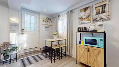 a living room with a tv and a small table at New Bright 1BR Basement Suite in York in Toronto