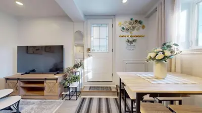 a living room with a table with a vase of flowers at New Bright 1BR Basement Suite in York in Toronto