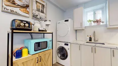 a kitchen with a washing machine and a microwave at New Bright 1BR Basement Suite in York in Toronto