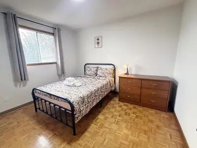 a bedroom with a bed and a dresser and a window at Relocation Ready- Pet-Friendly 4BR-Core of transit in Vaughan