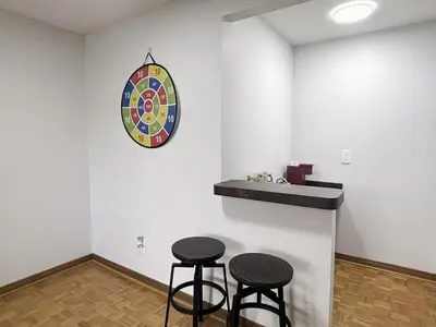 a bar with two stools and a clock on the wall at Relocation Ready- Pet-Friendly 4BR-Core of transit in Vaughan