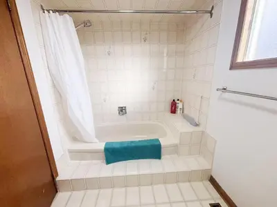 a bathroom with a bath tub with a blue towel at Relocation Ready- Pet-Friendly 4BR-Core of transit in Vaughan