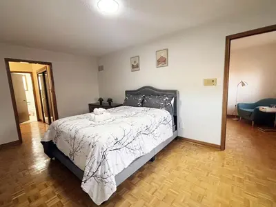 a bedroom with a bed and a mirror at Relocation Ready- Pet-Friendly 4BR-Core of transit in Vaughan