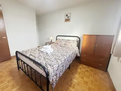 a bedroom with a bed and a dresser at Relocation Ready- Pet-Friendly 4BR-Core of transit in Vaughan