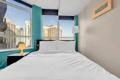 a bedroom with a bed and a large window at 2 bedroom spacious apartment in Mississauga in Mississauga