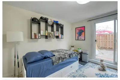 a bedroom with a bed and a window at Picturesque 3-story townhouse in Toronto
