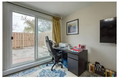 an office with a desk with a computer and a window at Picturesque 3-story townhouse in Toronto