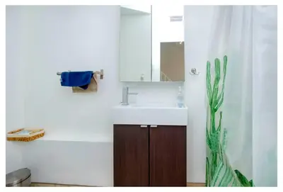 a bathroom with a sink and a toilet and a shower at Picturesque 3-story townhouse in Toronto