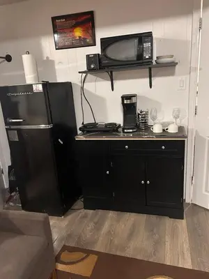 a kitchen with a black refrigerator and a microwave at Pau-Rae's Cozy Spot - your home away from home! in Thornhill