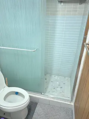 a bathroom with a toilet and a glass shower at Pau-Rae's Cozy Spot - your home away from home! in Thornhill