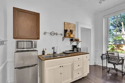 a kitchen with a sink and a refrigerator at Spacious 1 bed 1 bath Apt Close to Downtown and Beach in Cobourg