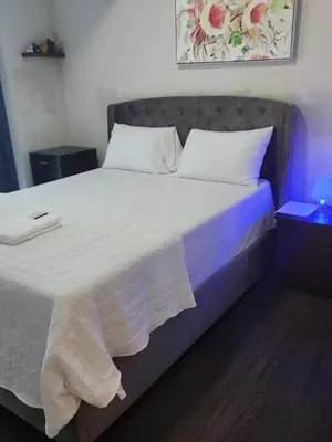 a bedroom with a large bed with white pillows at Kanp version shared Apartments Toronto in Toronto