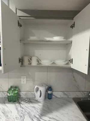 a kitchen with white cabinets and white counter tops at New 2 bedroom basement in Cambridge in Cambridge