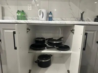 a kitchen with two pots and pans on a shelf at New 2 bedroom basement in Cambridge in Cambridge