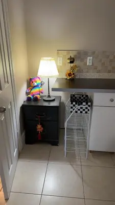 a room with a desk with a lamp and a chair at Comfortable Basement Private Room with Ensuite Near Plaza in Richmond Hill