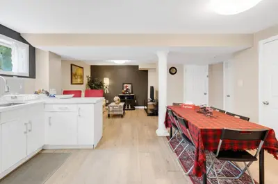 a kitchen with a table with a red table cloth at Comfortable Basement Private Room with Ensuite Near Plaza in Richmond Hill