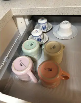 a refrigerator filled with different colored bowls and cups at Comfortable Basement Private Room with Ensuite Near Plaza in Richmond Hill